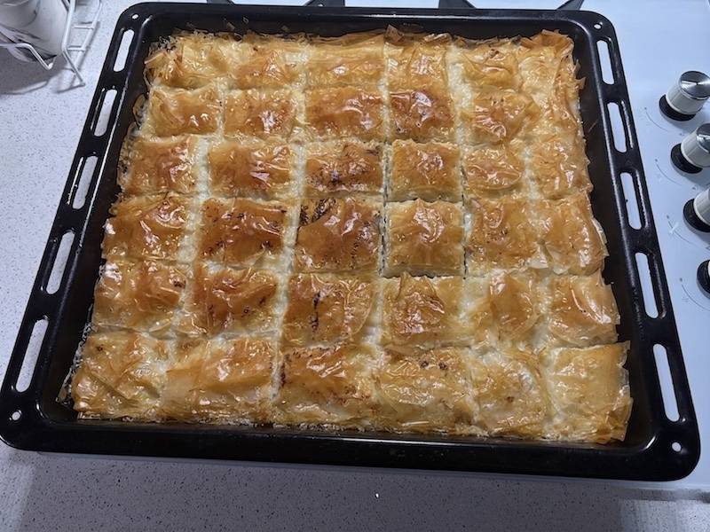 Sütlü Nuriye Turkish milk syrup baklava sliced into squares on a tray